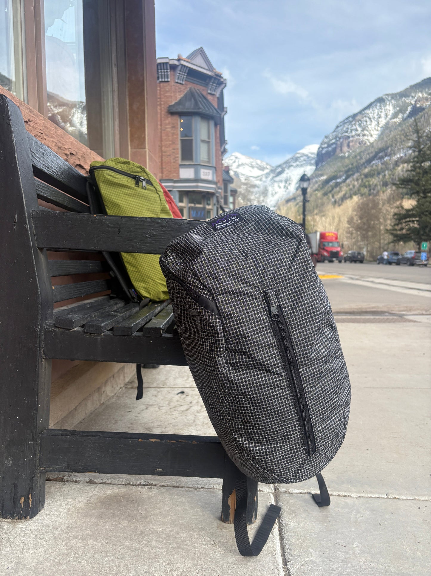 Black and white Jagged Edge Ajax Pack hanging off a bench on Main Street in Telluride, Colorado