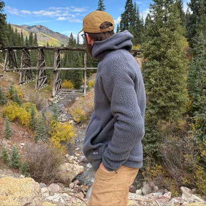 A person standing in front of the Telluride Trestle wearing the Jagged Edge High Pile Fleece Hoodie