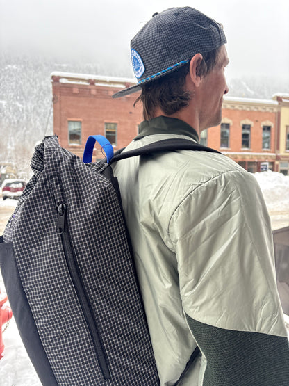 Person wearing the Jam Pack from the side where you can see the packs side zipper