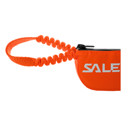Orange bag with a coiled strap that holds energy absorbing webbing for a via ferrata lanyard 